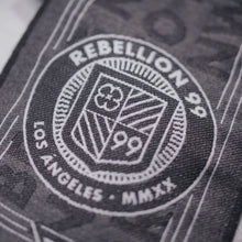 Load image into Gallery viewer, Close up of Rebellion 99 crest on scarf.
