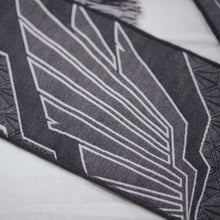 Load image into Gallery viewer, Close up of geometric wings on scarf.
