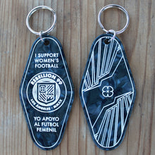 Load image into Gallery viewer, Both front and back side of Rebellion 99 keychain are shown against a wooden background. The black acrylic engraved keychain is shown and details are filled with white enamel to form the design. A silver keychain is attached at the top of each keychain.
