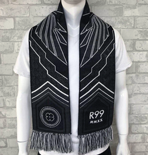 Load image into Gallery viewer, Inaugural scarf pictured on mannequin. Black, grey, and white scarf features &quot;REBELLION 99&quot; , crest, and &quot;Bring NWSL to LA&quot; on one side with geometric wings, &quot;R99&quot;, &quot;MMXX&quot;, and the California poppy flower on the reverse side. Background design of scarf features geometric Art Deco embellishments.
